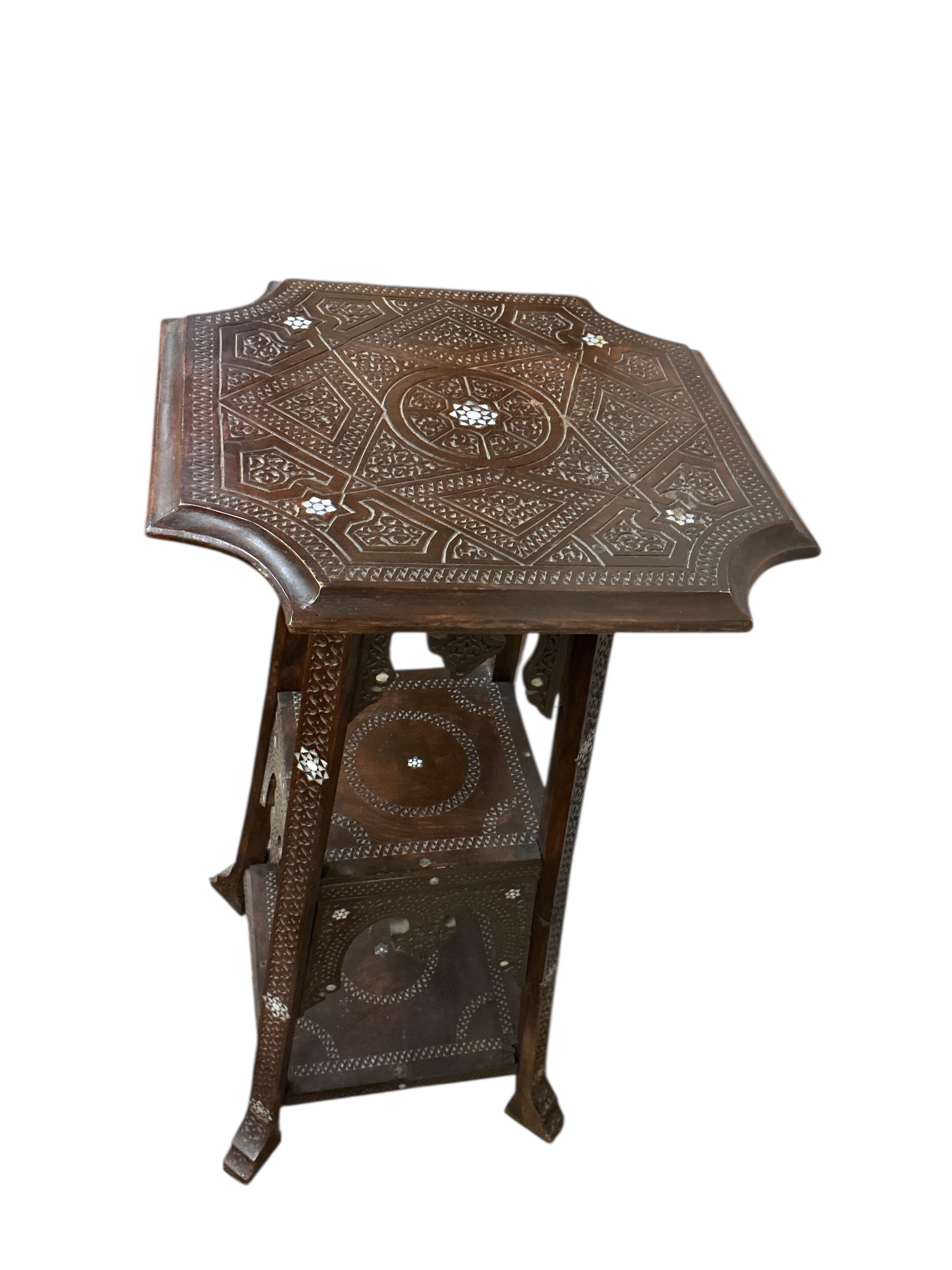 A Damascan mother of pearl inlaid carved hardwood three tier plant stand, width 48cm, height 102cm
